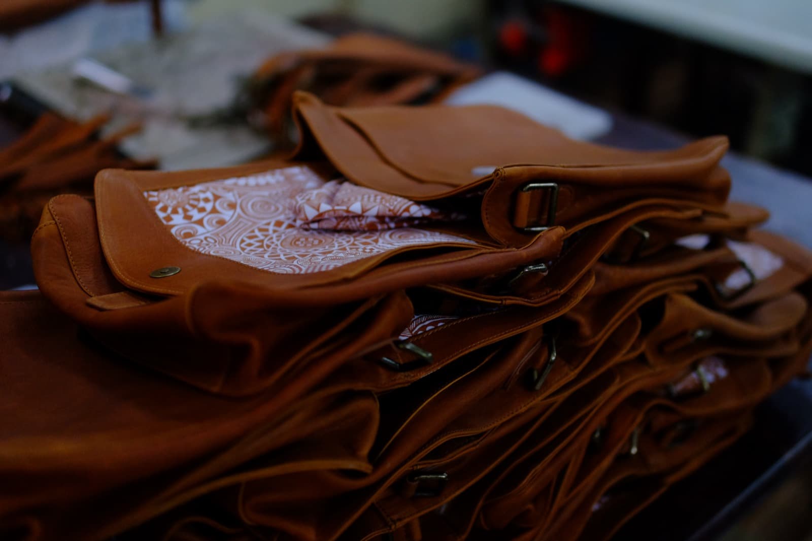 Stacked leather satchels with patterned lining