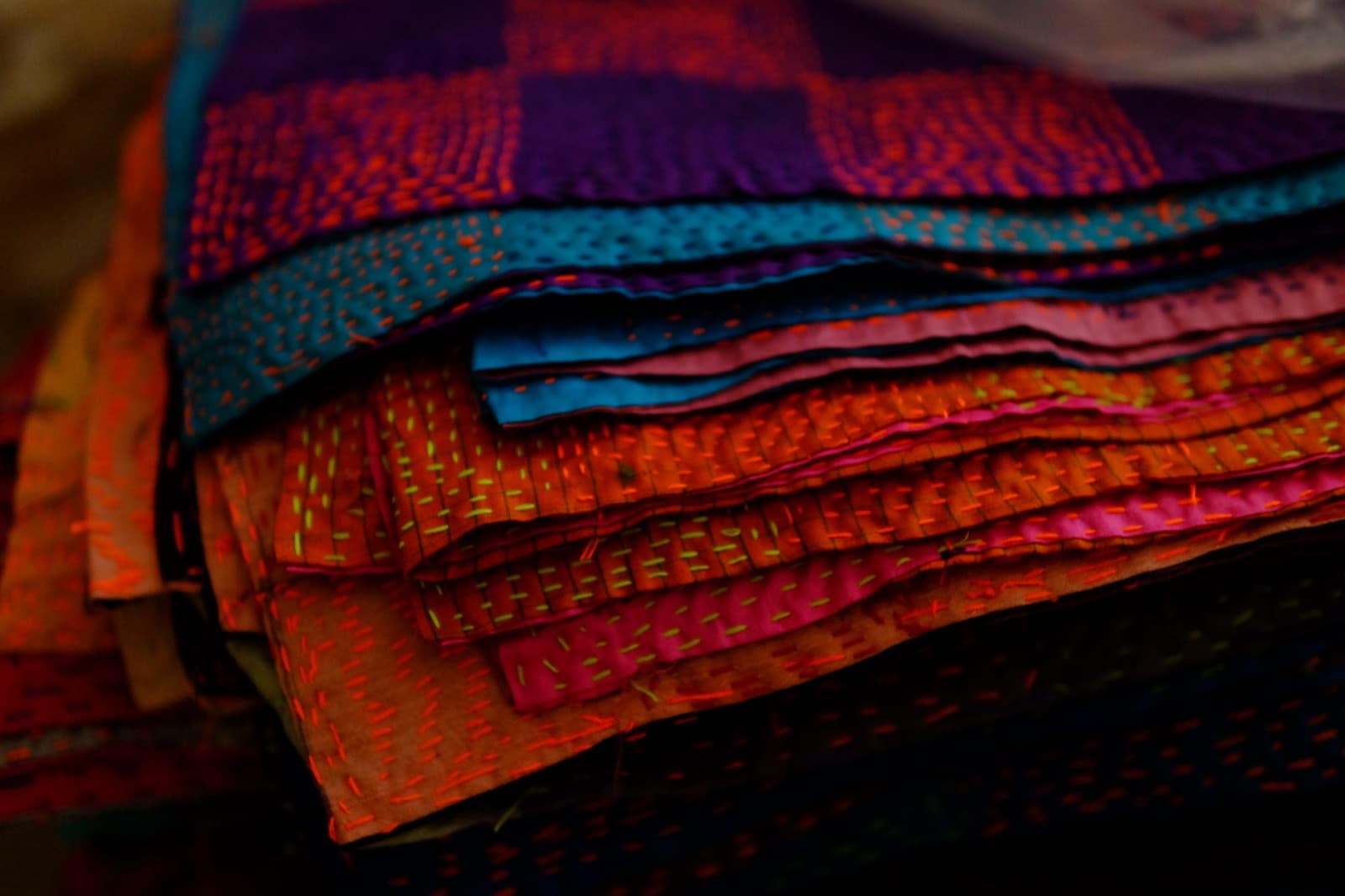 Stack of hand-stitched kantha textiles